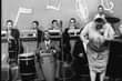 May be an image of one or more people, people standing and people playing musical instruments