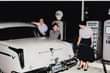 May be an image of 3 people, people standing and car