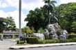 May be an image of 3 people, people standing, outdoors, monument and palm trees